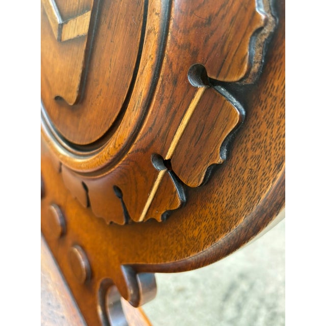 A charming and unusual pair of English Regency style (1811-18300 oak hall chairs featuring distinctive circular backs with...