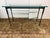 Design Plus Gallery presents a Console Table in the Style of Giametti. The console has a slender, hand-forged wrought iron...