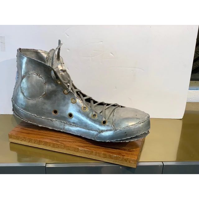 A marvelous sculpture of a Converse Chuck Taylor sneaker in Aluminum(?) or metal. A magnet does not adhere. It is hand...