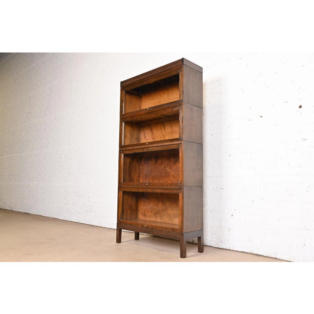 A gorgeous antique Arts & Crafts four-stack barrister bookcase By Shaw Walker USA, Circa 1920s Mahogany, with glass front...