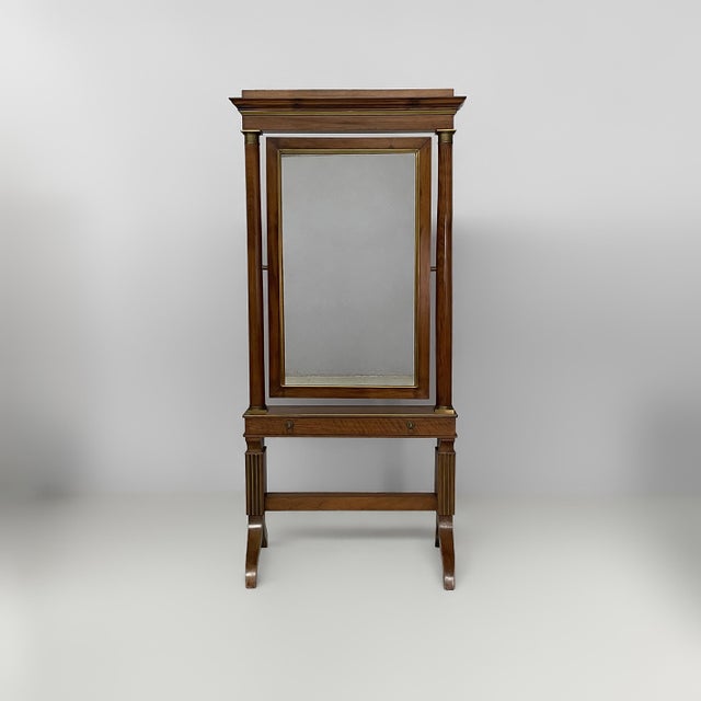 Italian empire mirror with drawer, mid-19th century Floor-standing wooden mirror, characterized by a vertical structure...