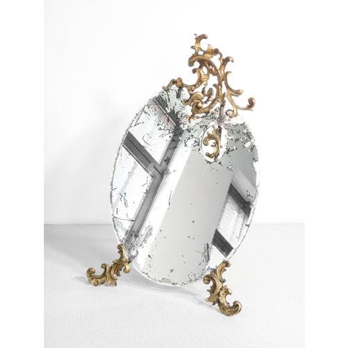 Table mirror with bronze frame in baroque style and mirror in the shape of a palette period early 20th century materials...