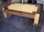 A two-tone birds eye maple coffee table with clipped corners. Finish is in a beige and medium-brown lacquer.