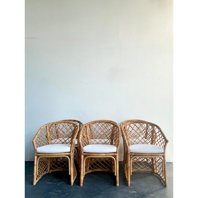 This curated set of six vintage rattan dining chairs effortlessly blends mid-century organic form with relaxed, coastal...