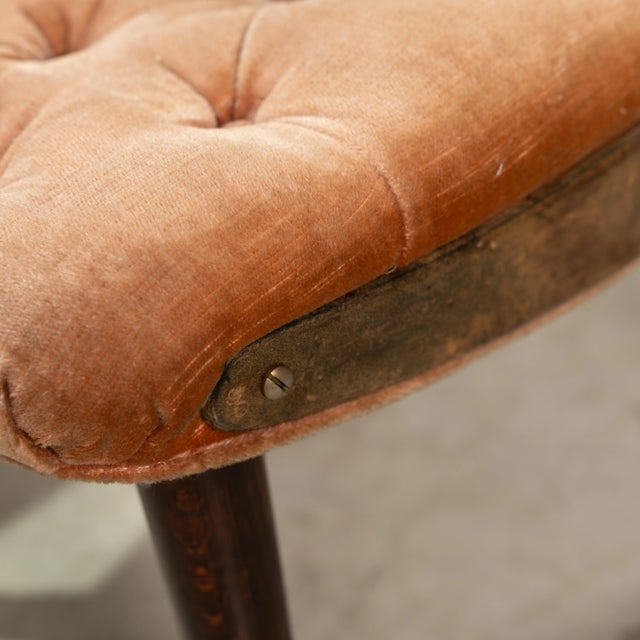 A set of eight tufted dining chairs with goatskin sides and wooden legs by Aldo Tura. All measurements are in inches....