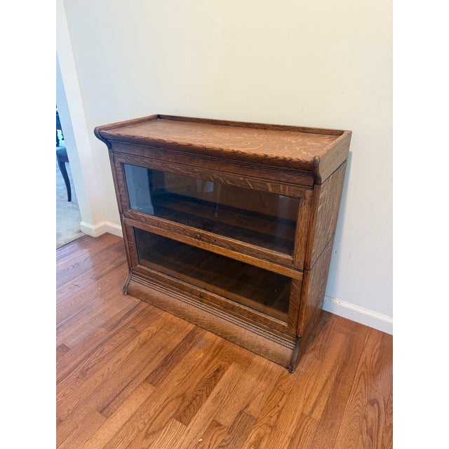 Two Stack Barrister Bookcase by Gunn Furniture Co. This antique two stack barrister bookcase has an oak case with two lift...