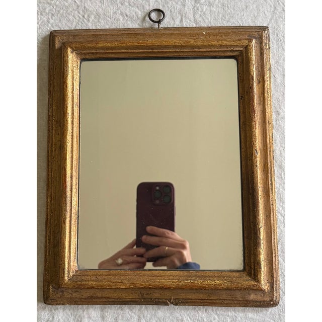 A small vintage Italian Borghese giltwood wall mirror, mid 20th century. The frame features a simple stepped wood profile,...