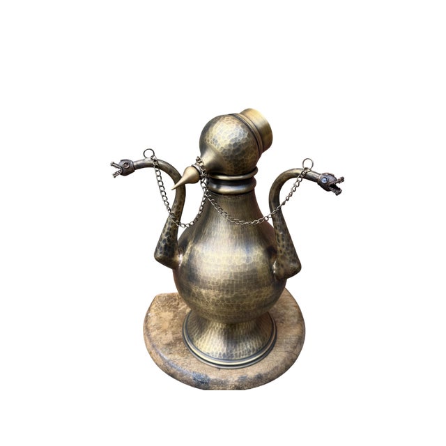 A striking focal point for eclectic interiors, this heavy brass ewer showcases the raw character of traditional hand-...