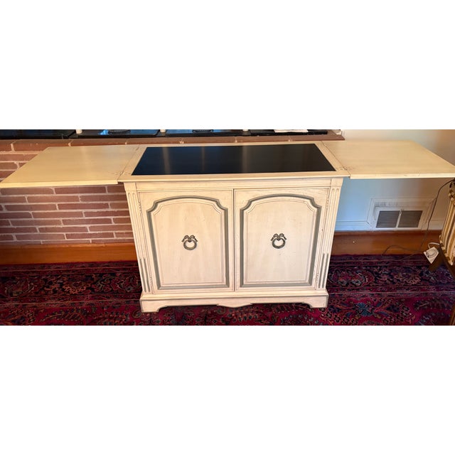 French Provincial style flip-top server cabinet, likely manufactured by Thomasville. This piece is finished on all four...