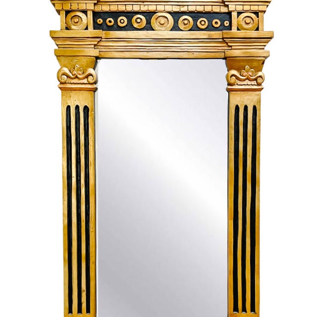 French Empire style ebonized giltwood wall mirror with large shell shaped rocaille pediment top. Carved giltwood.