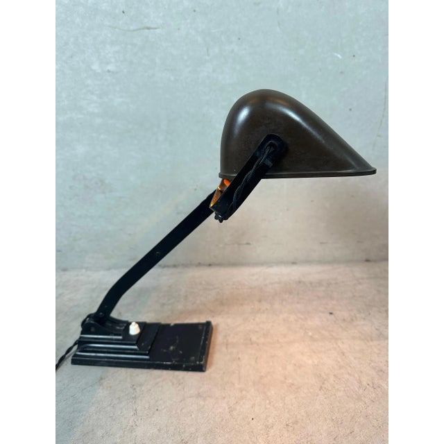 An ERPÉ notary lamp. Model 52. Aluminum base. Bakelite shade. No cracks. Bakelite E27 socket. Push button switch in the...