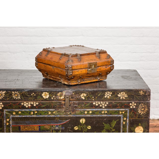 A Chinese Qing Dynasty period square shaped box from the 19th century with brass lock, metal hardware and distressed...