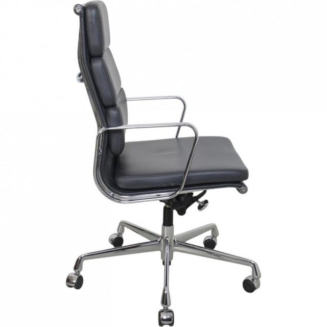 Charles Eames EA-219 office chair upholstered in grey leather, with chrome armrests and a chrome base. The chair is from...