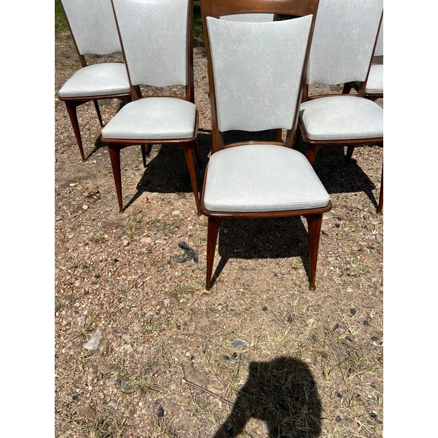 Set of 6 Mid-Century Modern Dining Chairs featuring elegant walnut frames with tapered legs and brass-capped feet. Newly...