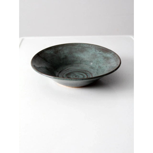 This is a vintage studio pottery bowl, signed by the artist. Handcrafted with a softly organic form, the bowl features a...