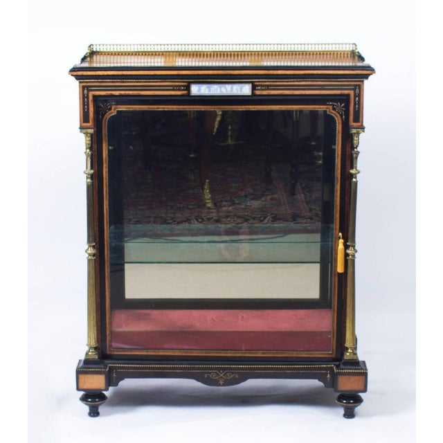 This is a beautiful antique Victorian amboyna and ebonised pier cabinet, circa 1850 in date. The rectangular amboyna top...
