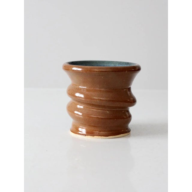 Add charm and eye-catching texture to any room with this vintage studio pottery vase. This handmade cachepot is sure to...