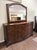 This transitional dresser features a gently bowed front, richly patterned burled-finish drawer fronts, and nine spacious...