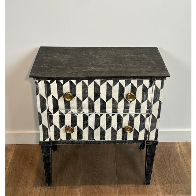 This beautiful and decorative little chest of drawers with two drawers features a trompe-l'oeil patinated checkerboard. It...