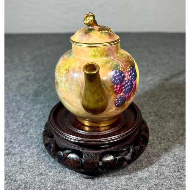 Royal Worcester Orchard pattern miniature tea pot hand painted and artist signed. Depicting an exquisite fruit motif of...