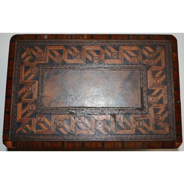The walnut and cedar inlay is spectacular on this box from the early 20th century. The inside is lined with paper in a...