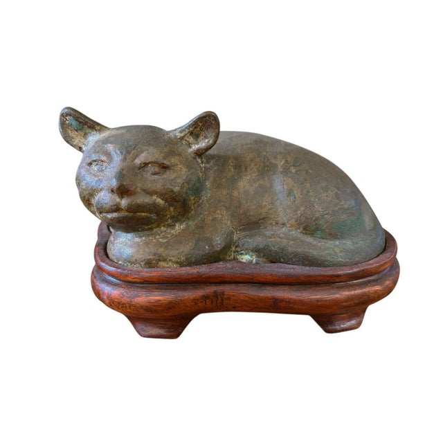 Old Bronze Chinoiserie Cat Figure Han Style Recumbent Kitten Sculpture on carved brown wood stand . This charming Han-...