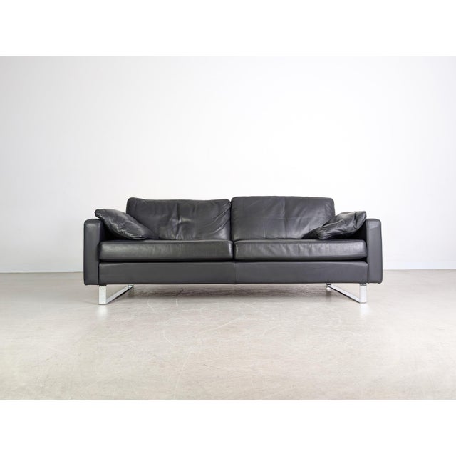 We are offering a beautiful cor conseta three-seater sofa in black leather for sale. A matching two-seater sofa, also in...