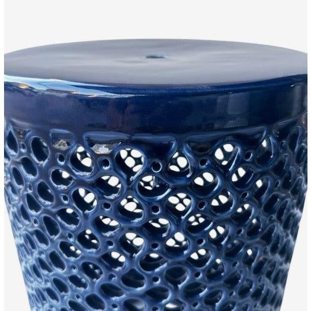 The Lanie Garden Stool is a ceramic garden stool with a cylindrical form and an allover openwork lattice pattern in a...