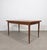 Vintage Scandinavian extendable dining table in teak with a rectangular top, rounded corners and tapered legs. The table...