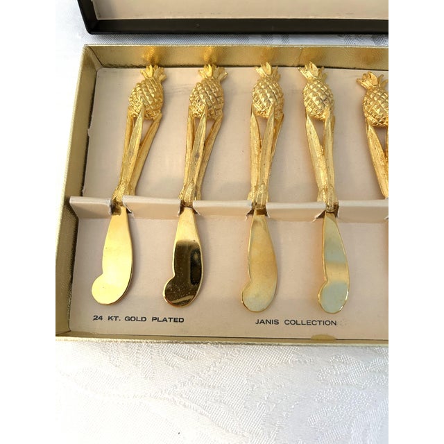 Glamorous set of six mid-century 24 karat gold plated Janis Collection cocktail spreaders with a figural pineapple motif....