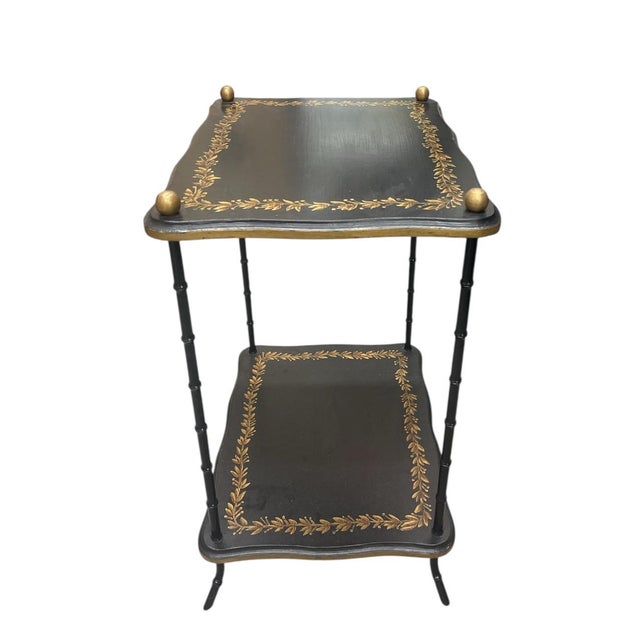This elegant two-tier occasional table, a perfect blend of Hollywood Regency glamour and French Provincial charm. This...