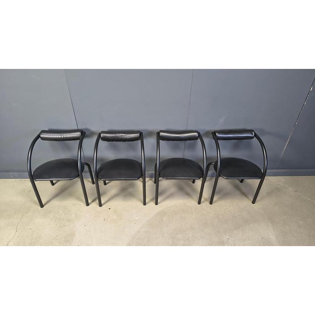 Post modern dining chairs with black lacquered metal tubular frames, black leatehrette upholstery. Attractive, timeless...