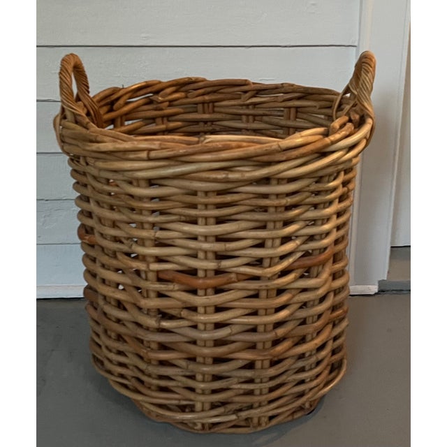Large English woven wicker basket for storing wood logs or kindling by the fireplace hearth. With loop handles for...