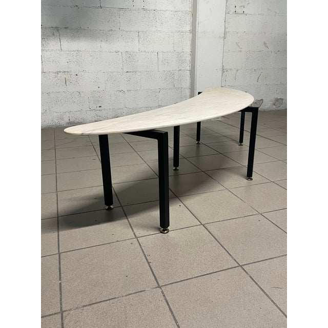 Rare and particular 1950s coffee table of Italian manufacture, with black painted tubular iron structure and brass feet....
