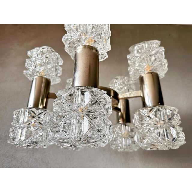 Beautiful mid century design. Lamp made in the seventies by the German Kaiser Leuchten. Chromed frame 5 arms. Each arm has...