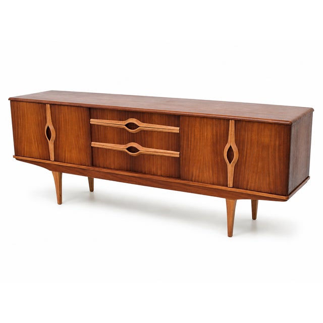 A superb 1960s Stonehill “Colony” teak sideboard, fully restored and showcasing some of the most distinctive sculptural...