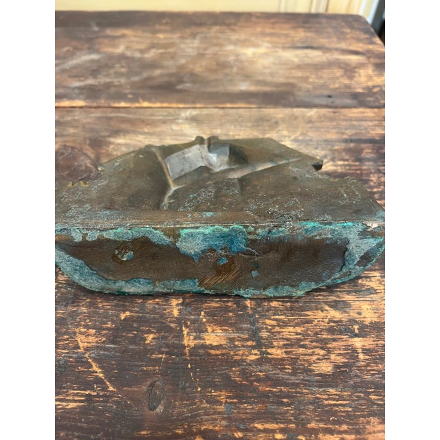 This is an antique doorstop. It features a "Cape Cod Cottage" design. It was made in the 1920s. It is adorable.