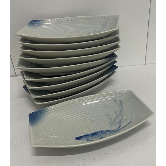 This set of 10 Gump porcelain koi plates have a nice raised relief. The imagery is graceful with the blue koi circling a...