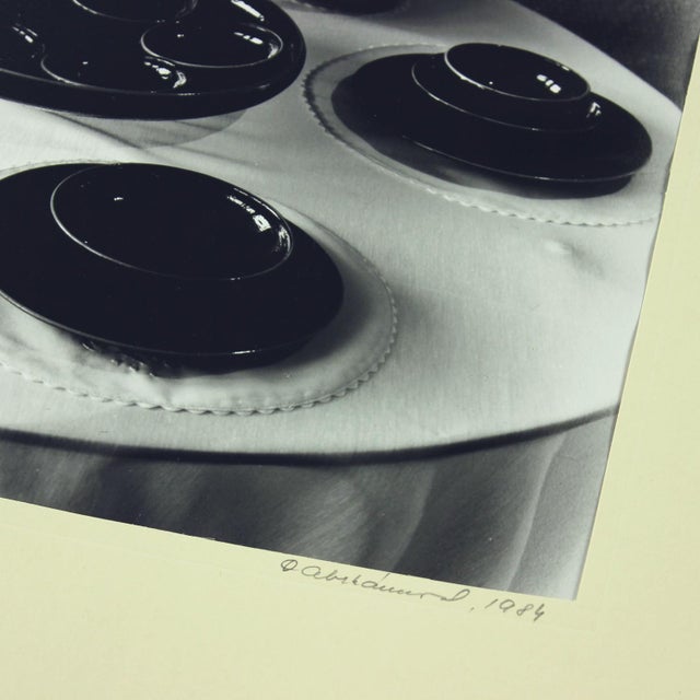 This elegant set of four black-and-white photographs captures the unique ceramic creations of renowned artist Ditta...