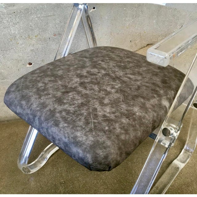 A stunning vintage Lucite side chair with chrome detailing and arms. This elegant piece is a perfect blend of modern...