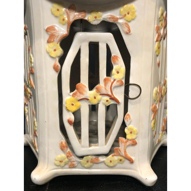 Vintage Italian Majolica glazed ceramic birdcage. Pagoda form in white with terracotta colored roof and yellow flowers....