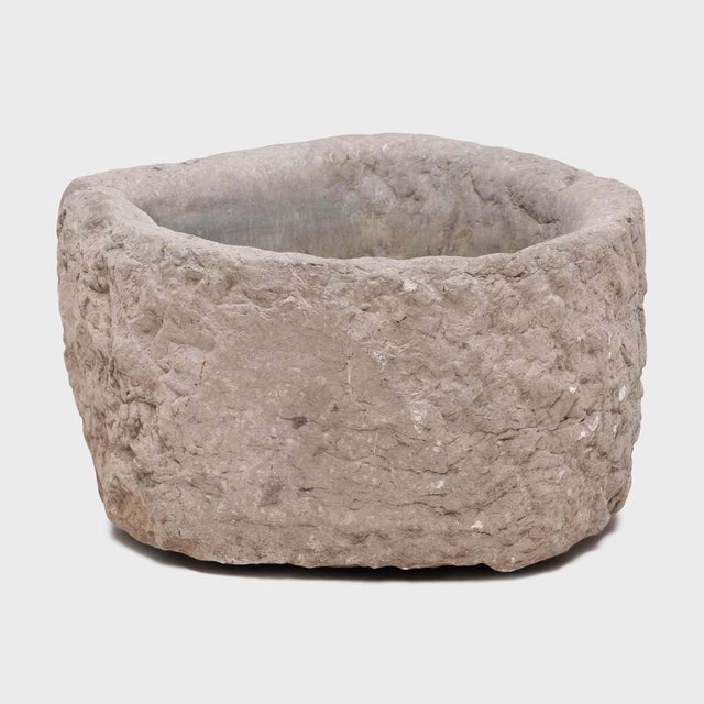 This stone basin was carved by hand nearly two centuries ago, sculpted from solid limestone to an unusual horseshoe shape....