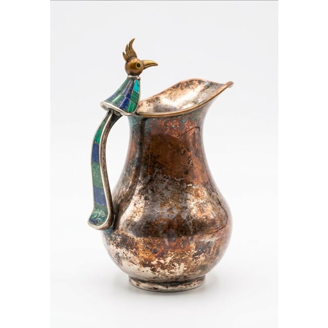 Up for sale is a stunning, authentic mid-century modern mixed-metal pitcher handcrafted by the world-renowned Los Castillo...