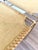 Pair of sculptural brass and animal hide accent benches featuring hand-laced hide and leather seats and slender brass-...