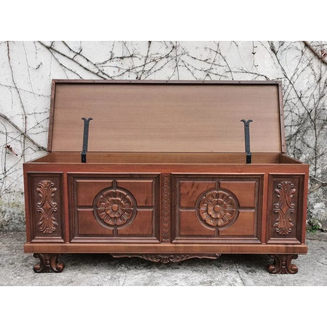 Chest of drawers in carved beech, walnut color '70s.