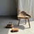 Small stool/footrest in organic, wabi-sabi style, carved from a single piece of blond teak. A charming, modular, Japanese-...