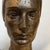 Sculpture of a face / bust of a woman in bronze with a light golden patina (dated 1961) by robert delnest. This work was...