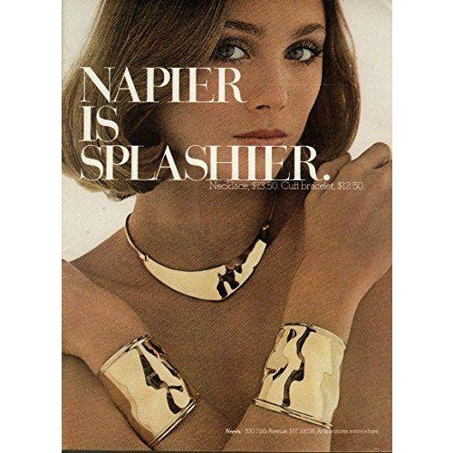 1977 "reflections" goldtone wide wavy with raised edge slip on tapered cuff bracelet. Marked "NAPIER©" near the side edge....