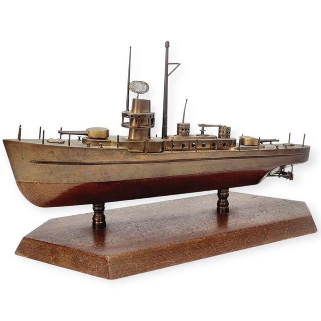 An exceptionally well-crafted decorative object made of wood and brass, created with remarkable attention to detail. The...