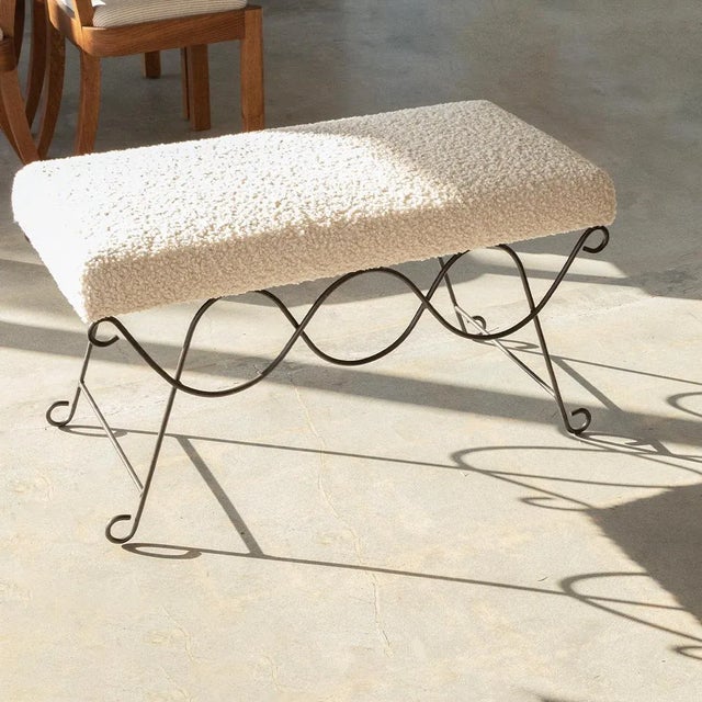 Beautiful iron bench with curved and looped base painted in a matte black finish inspired by French design. Rectangular...